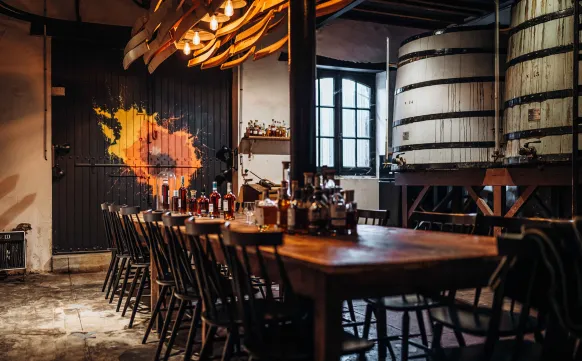 Large table with cognac bottle display Hotel Chais Monnet & Spa Cognac