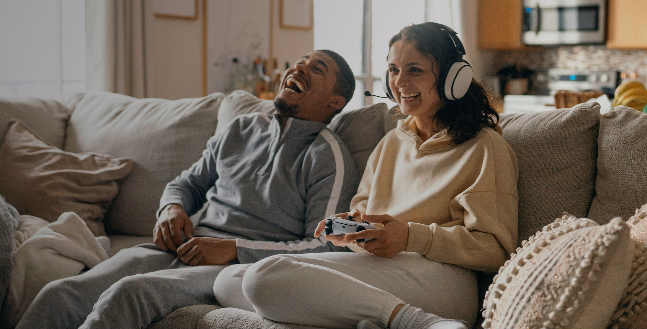 a couple sitting on the couch playing video game