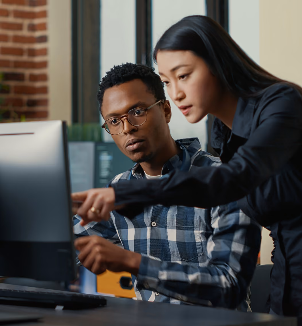 coworkers looking at computer in office