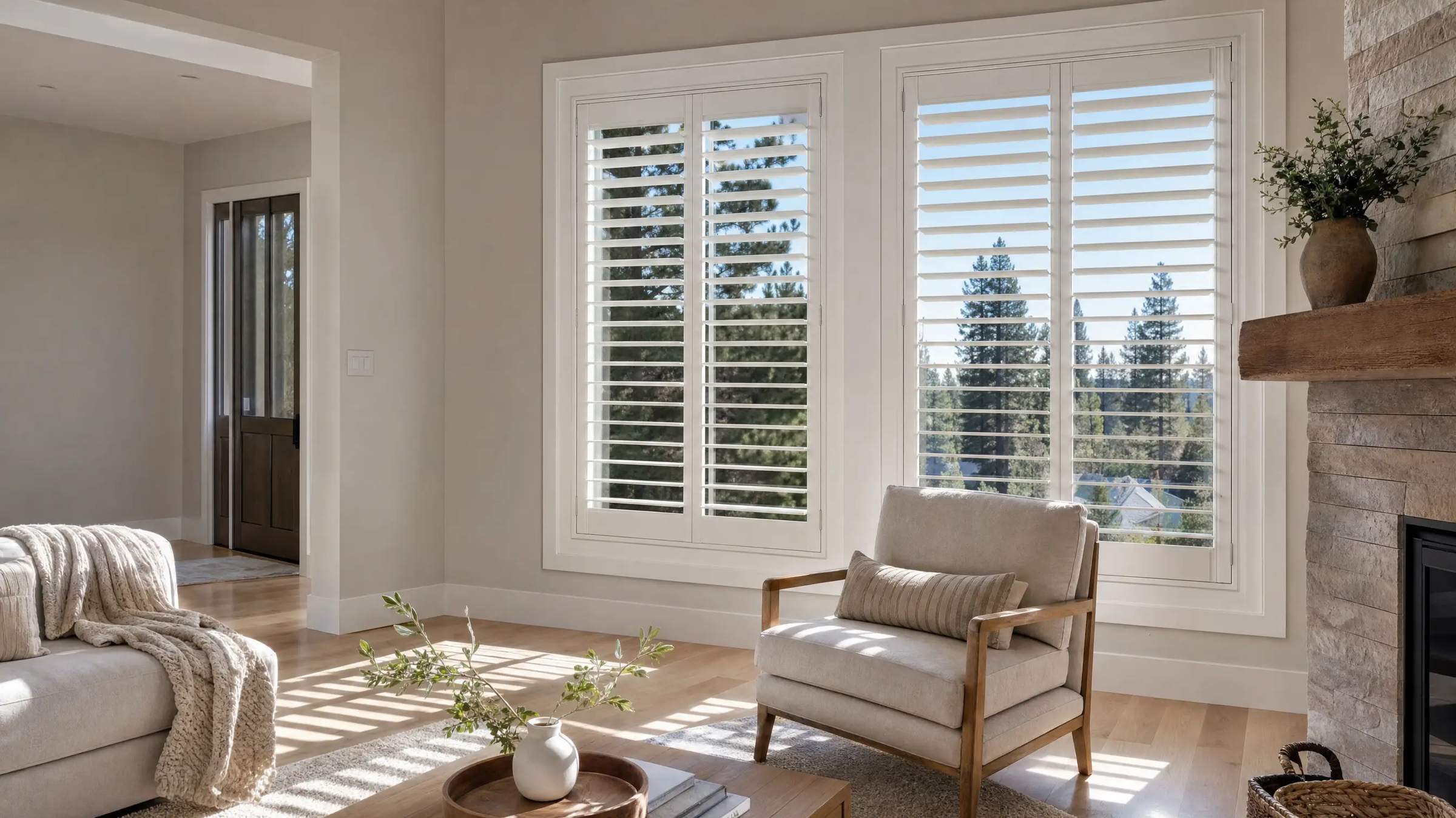 White custom interior shutters with louvers tilted open on a Spokane living room window