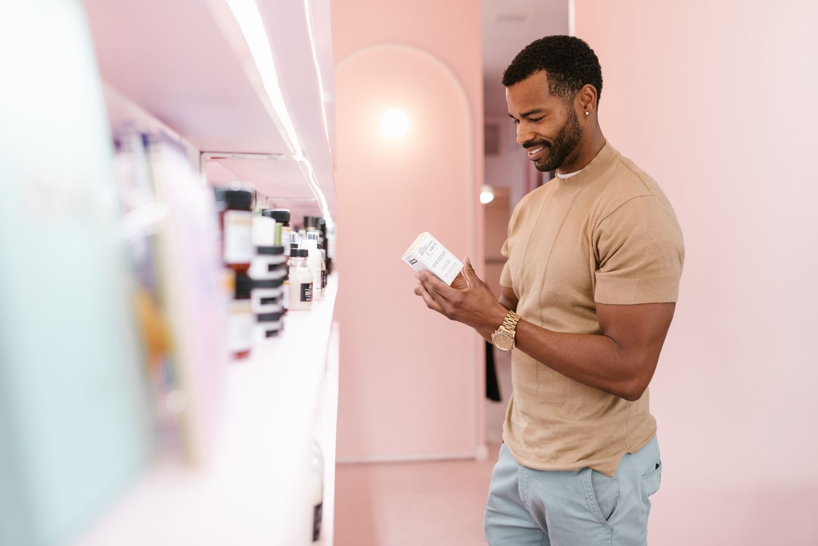 Shopper reading a skincare ingredient label to check if the product is malassezia safe