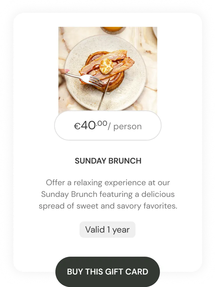 Hand cutting a stack of pancakes topped with butter and syrup on a grey plate for Sunday Brunch gift card.