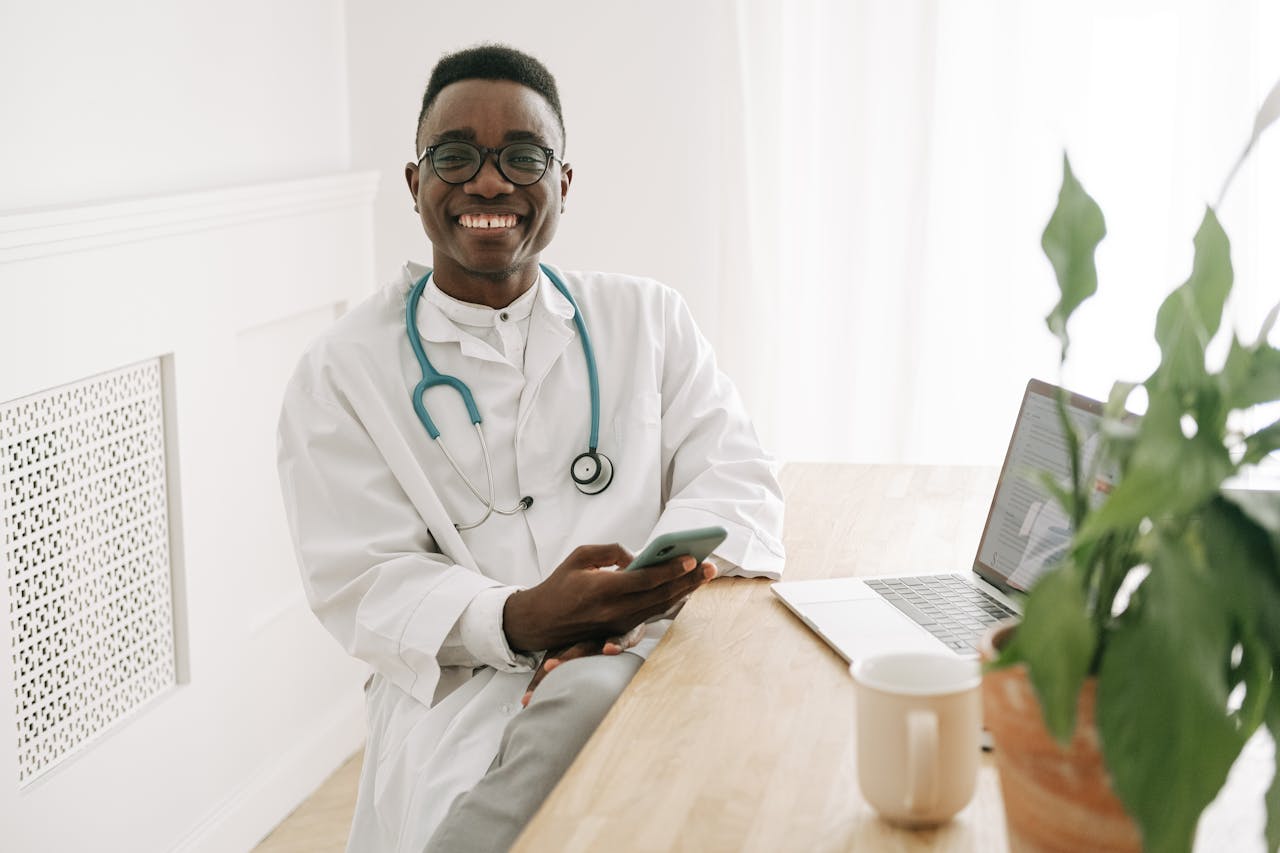 Doctor using a laptop and phone