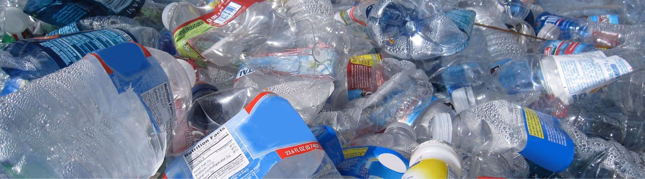 Pile of clear plastic PET bottles for recycling