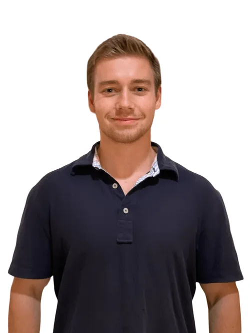Smiling young man wearing a dark polo shirt against a white background.