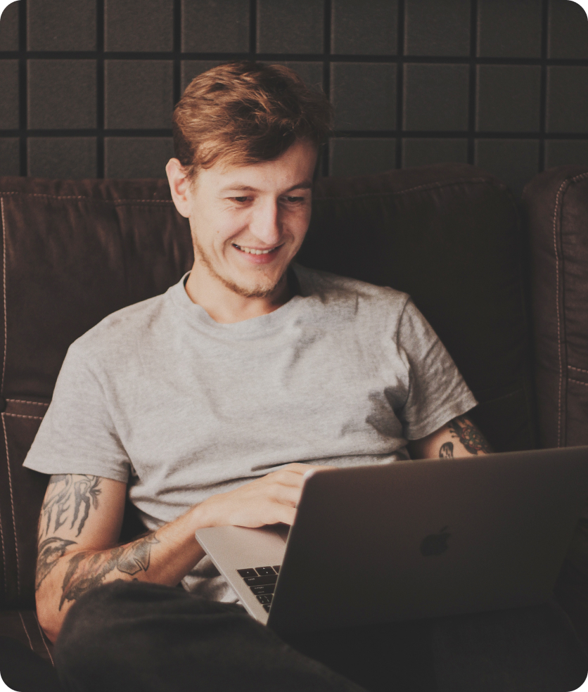 Portrait of a young man working on his laptop.