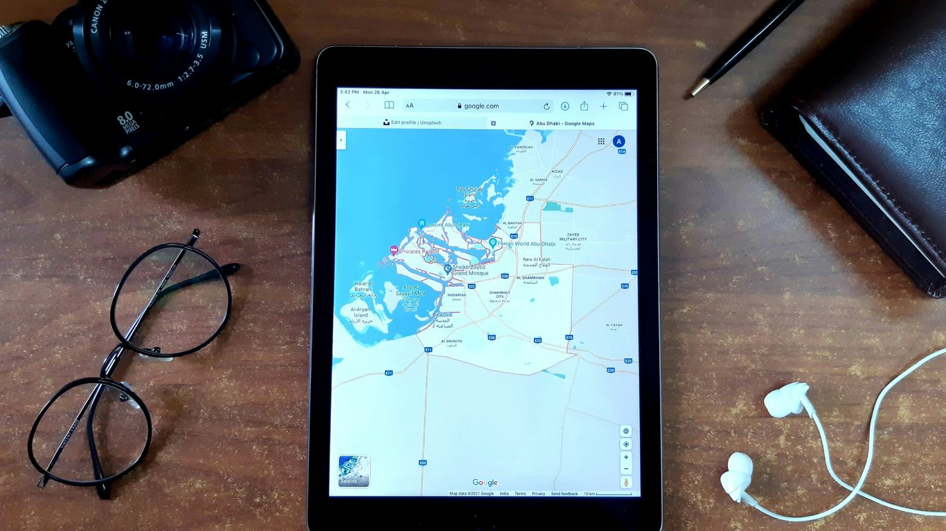 Black ipad on brown wooden table