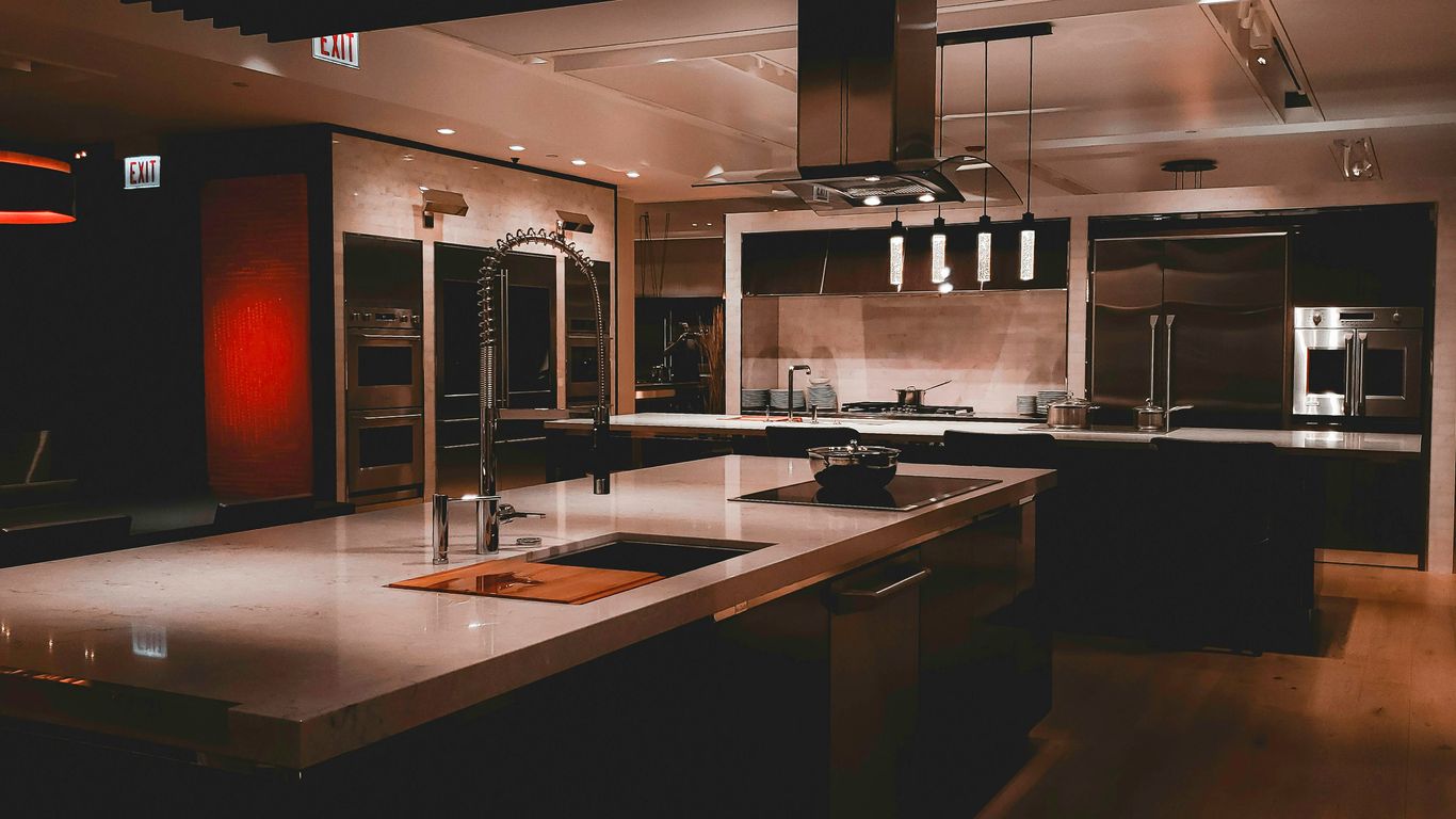 A large kitchen with a center island and stainless steel appliances