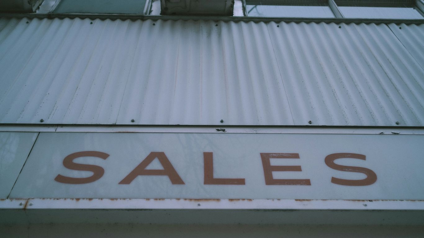 a sign that says sales on the side of a building