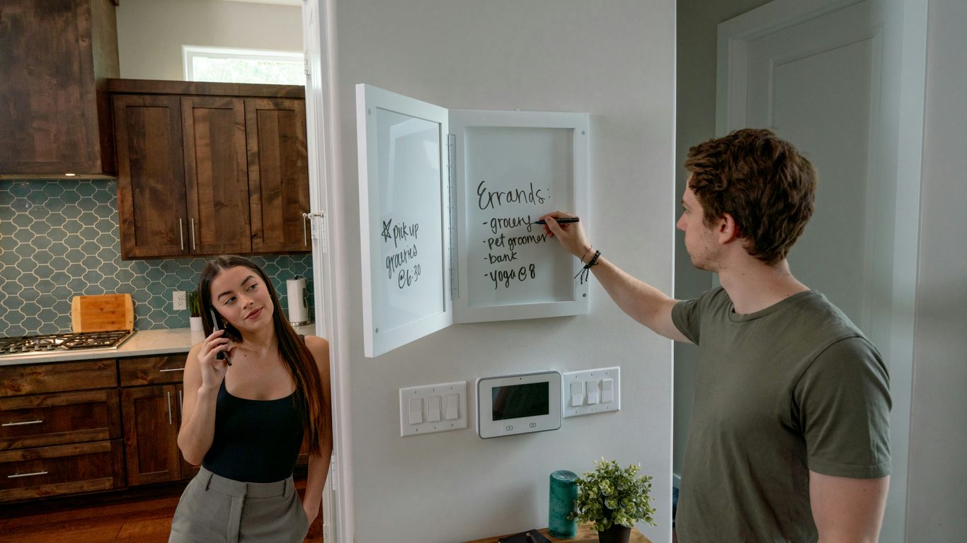 a man and a woman standing in a kitchen
