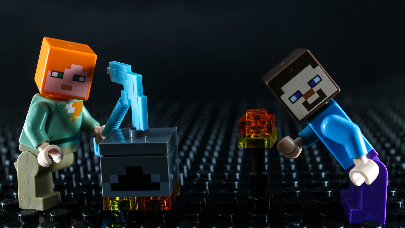 Two minecraft lego figures with crafting table