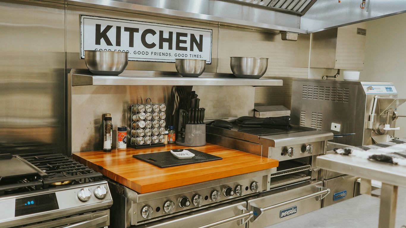 a kitchen with stainless steel appliances and a wooden counter