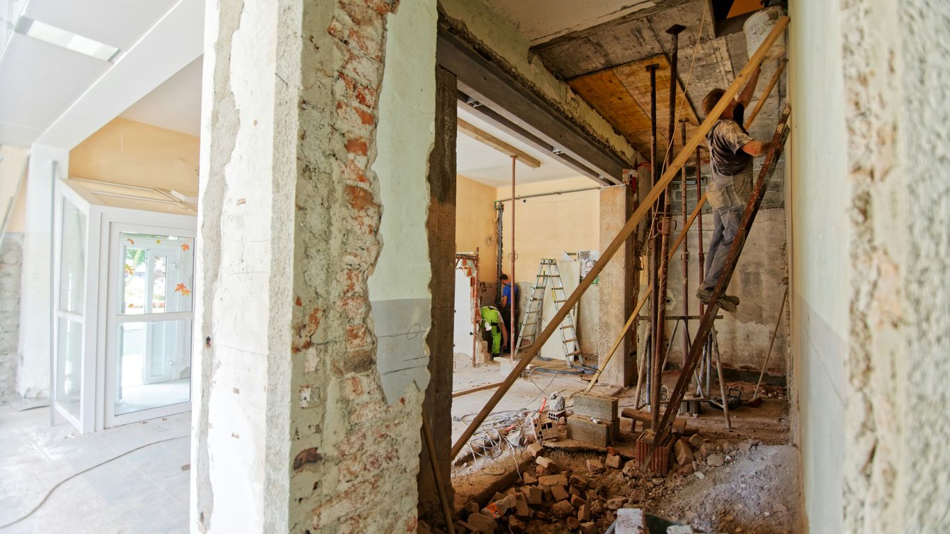 man climbing on ladder inside room