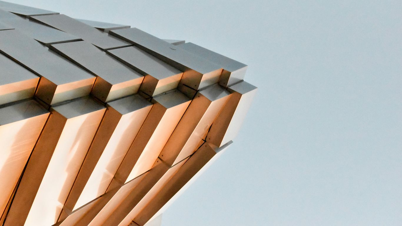 a close up of a metal structure with a sky background