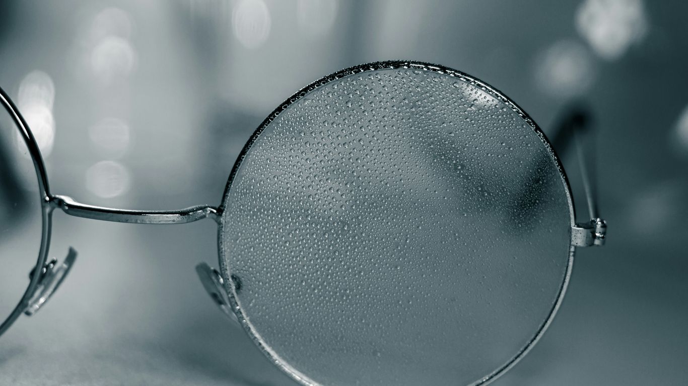 a pair of glasses sitting on top of a table