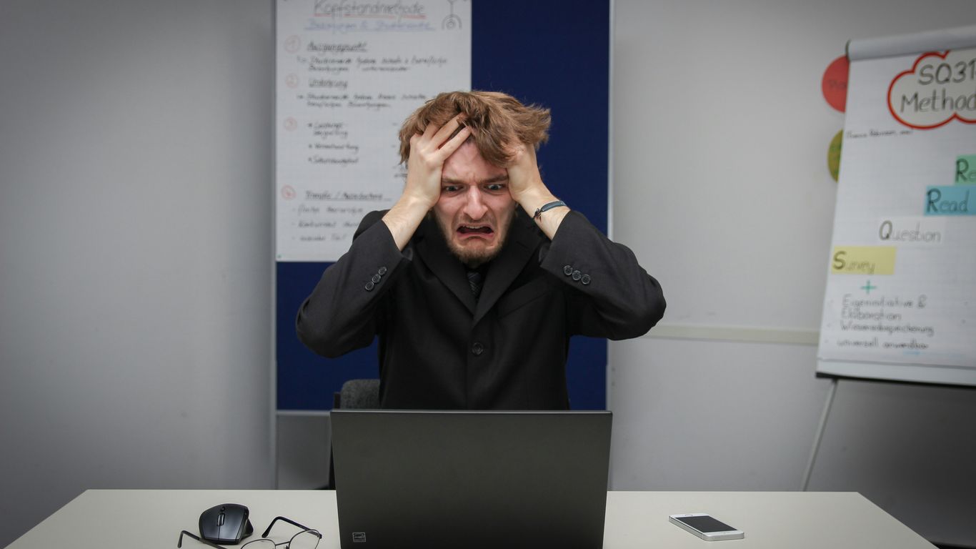 A man sitting in front of a laptop computer