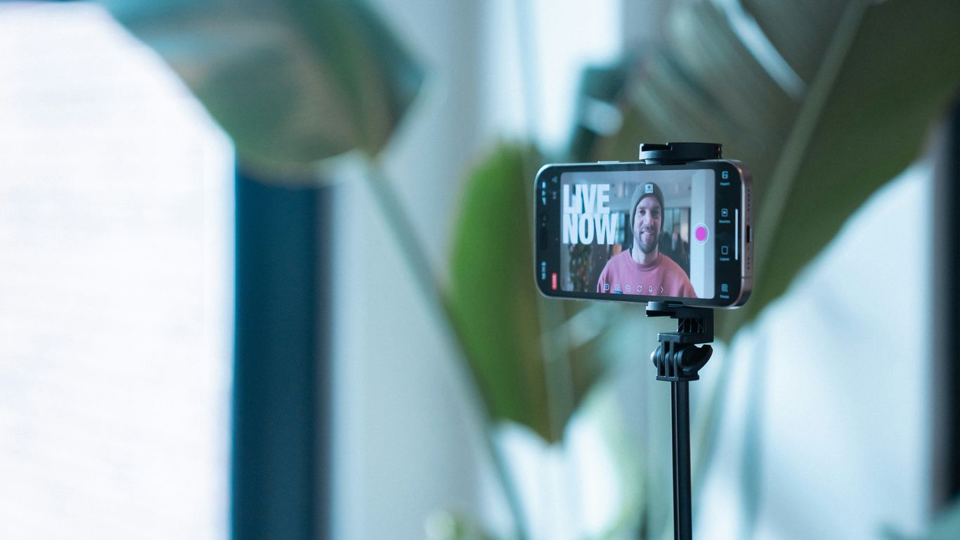 Man recording video on phone with 