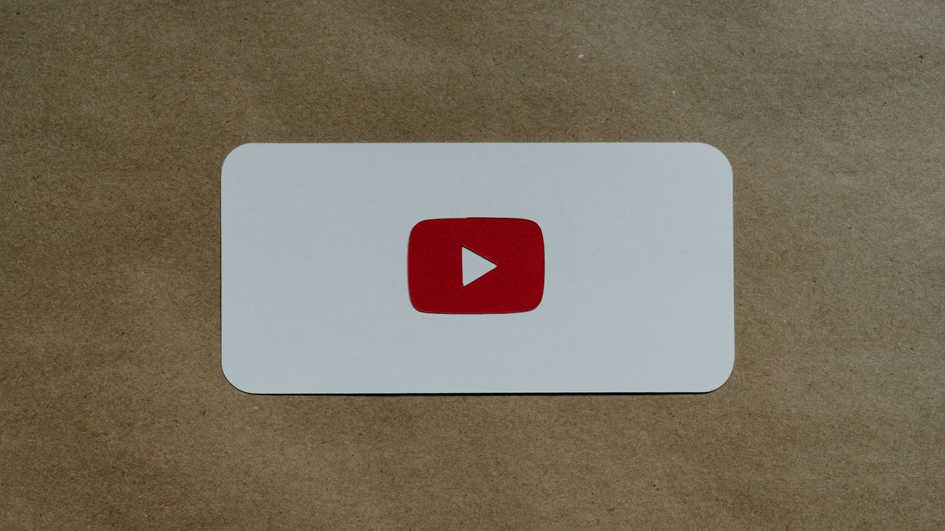 a white card with a red youtube logo on it