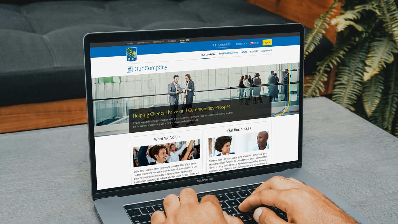 a man using a laptop computer on a table