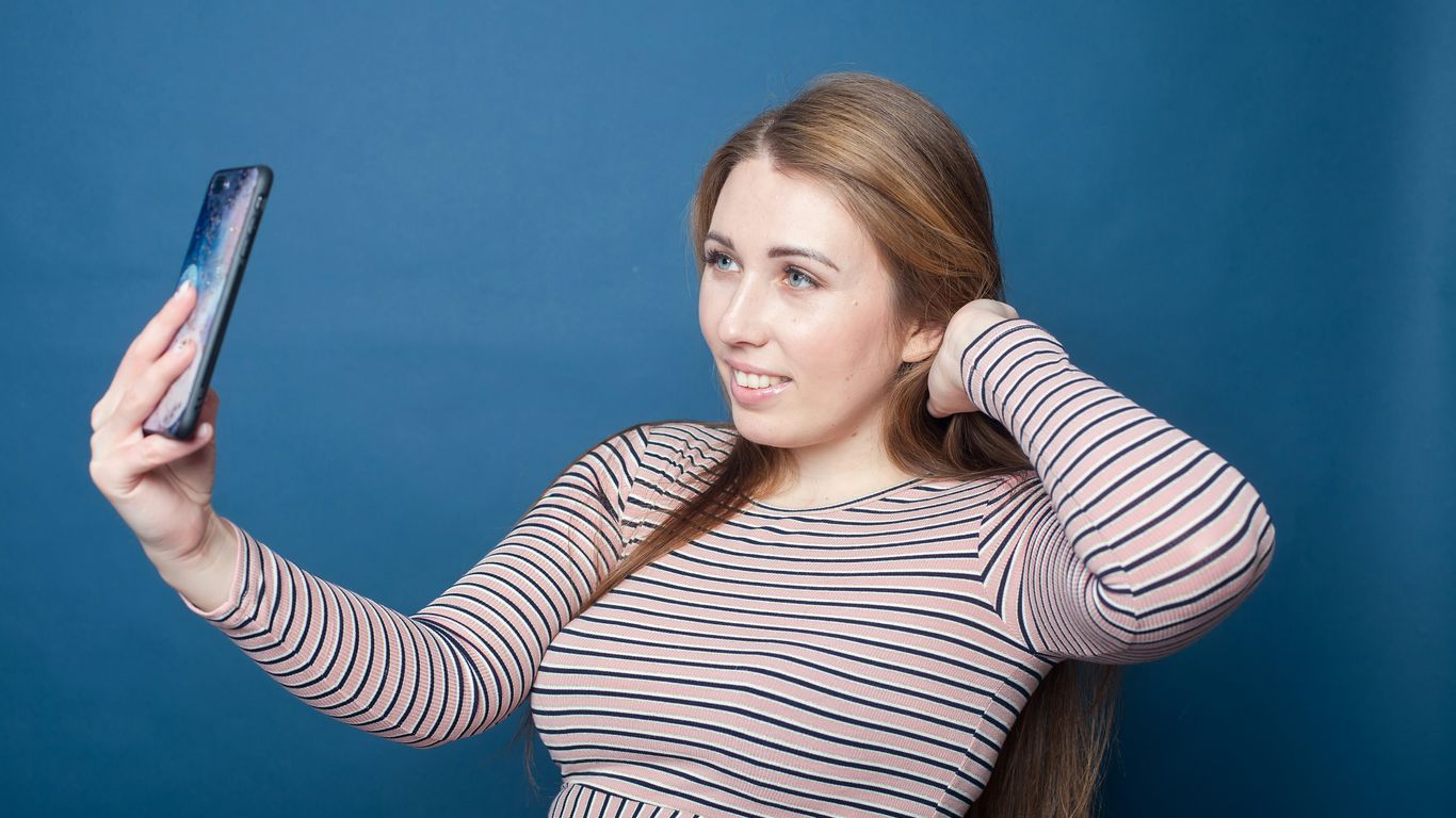 a woman holding a phone