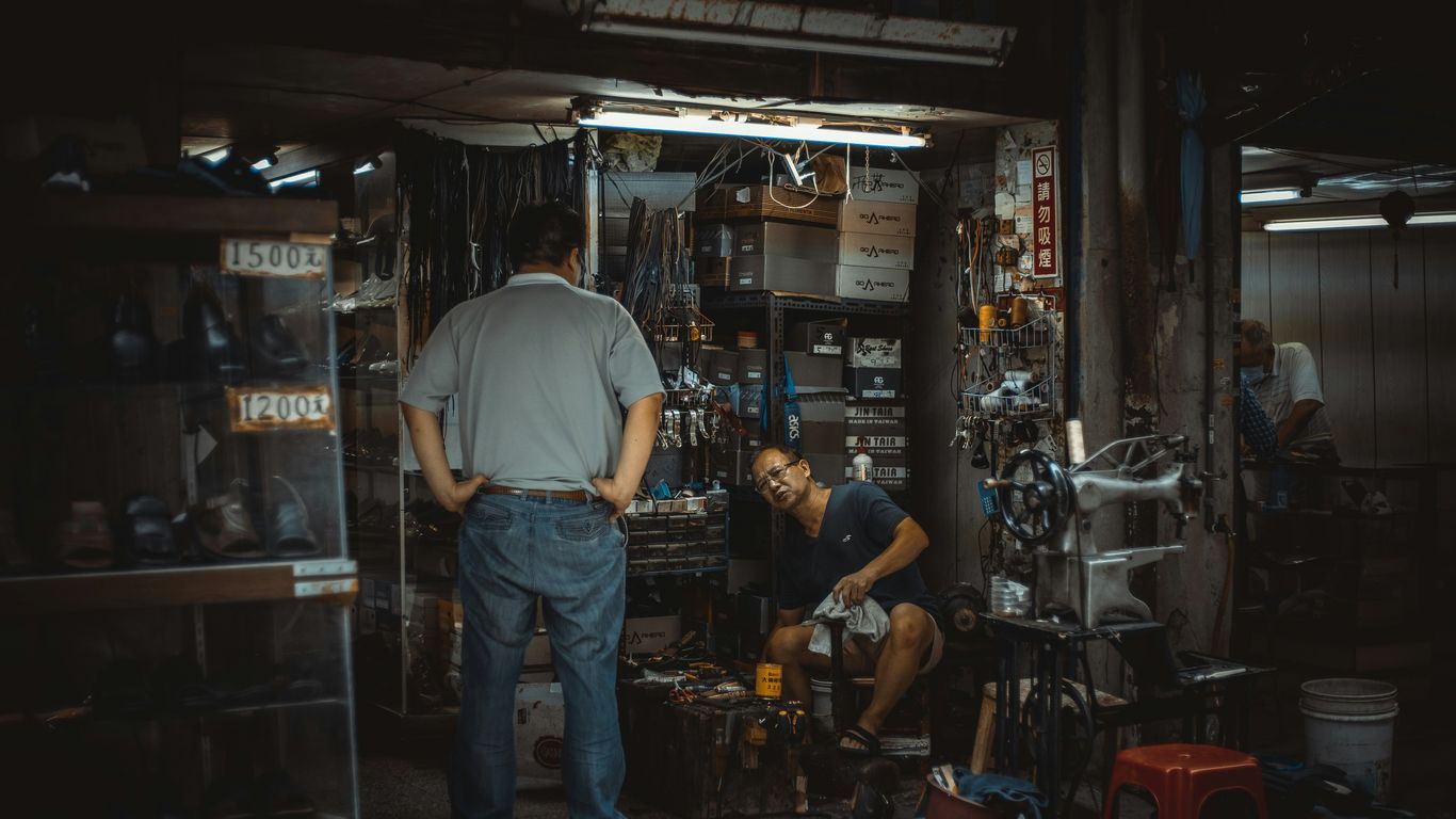 a man and a woman working in a shop