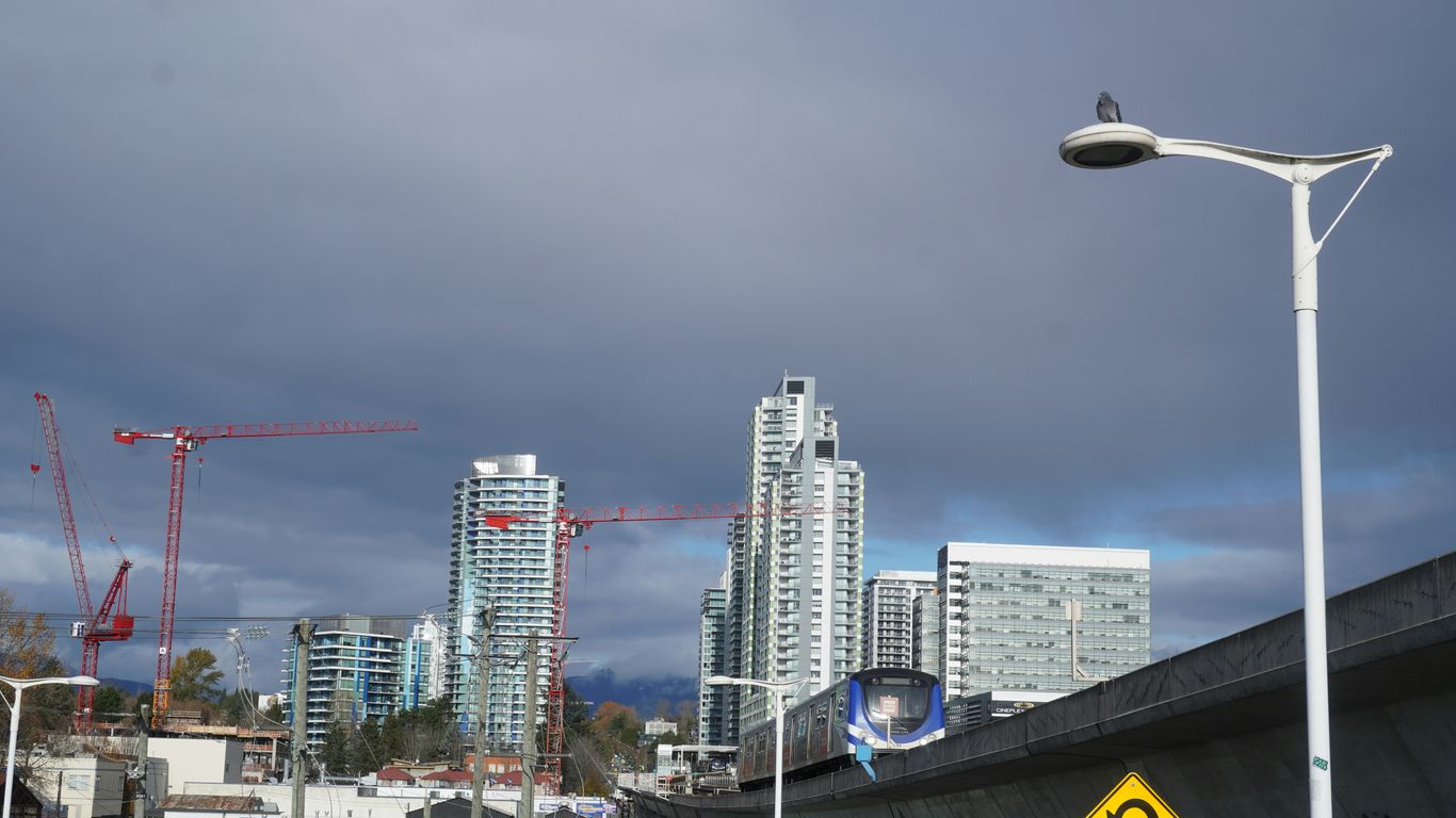 a street light on a city street with tall buildings in the background