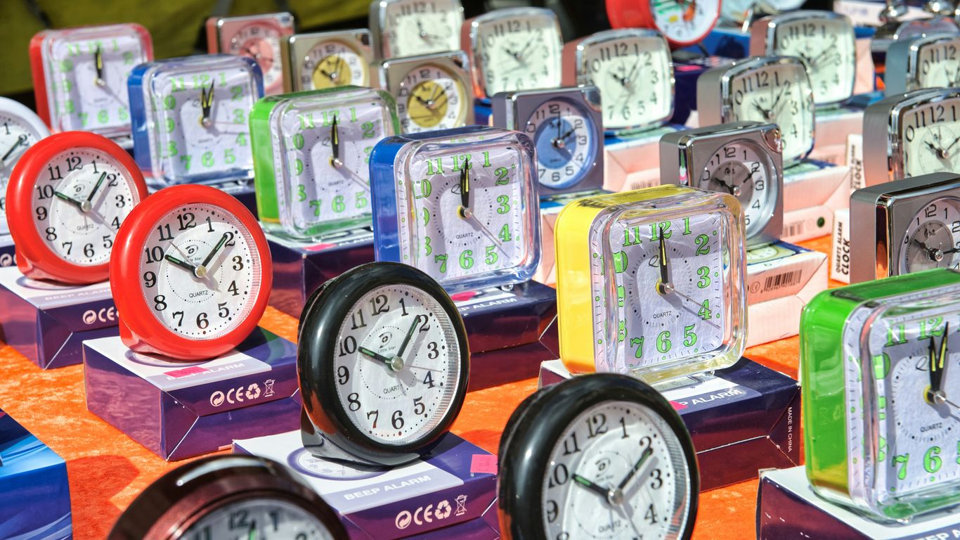 brown and white analog clock at 10 10