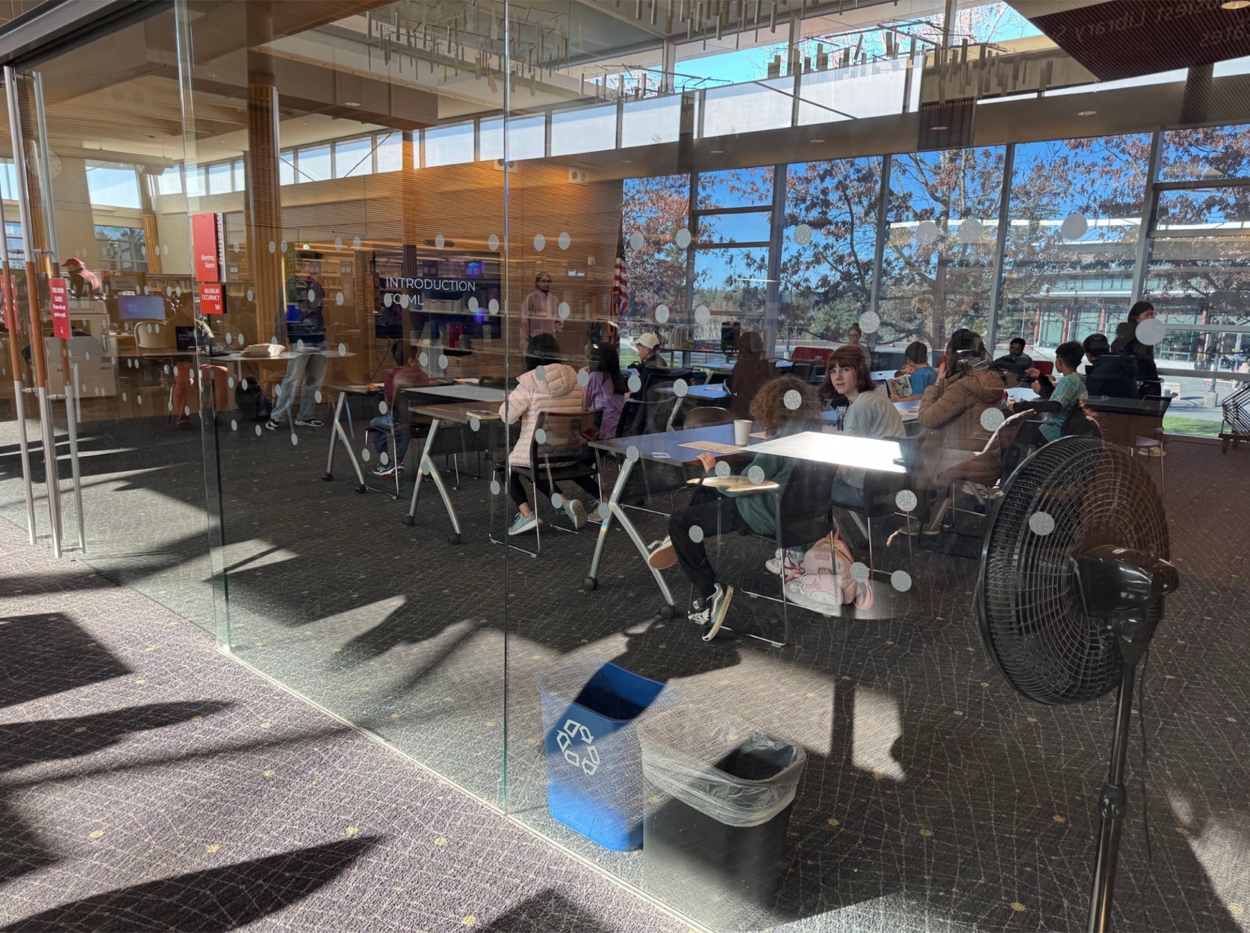 Volunteers hosting an introductory machine learning workshop at a local library