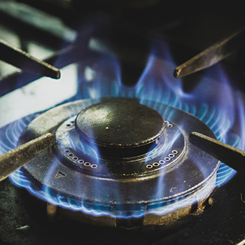 Ignited gas stove emitting a blue flame