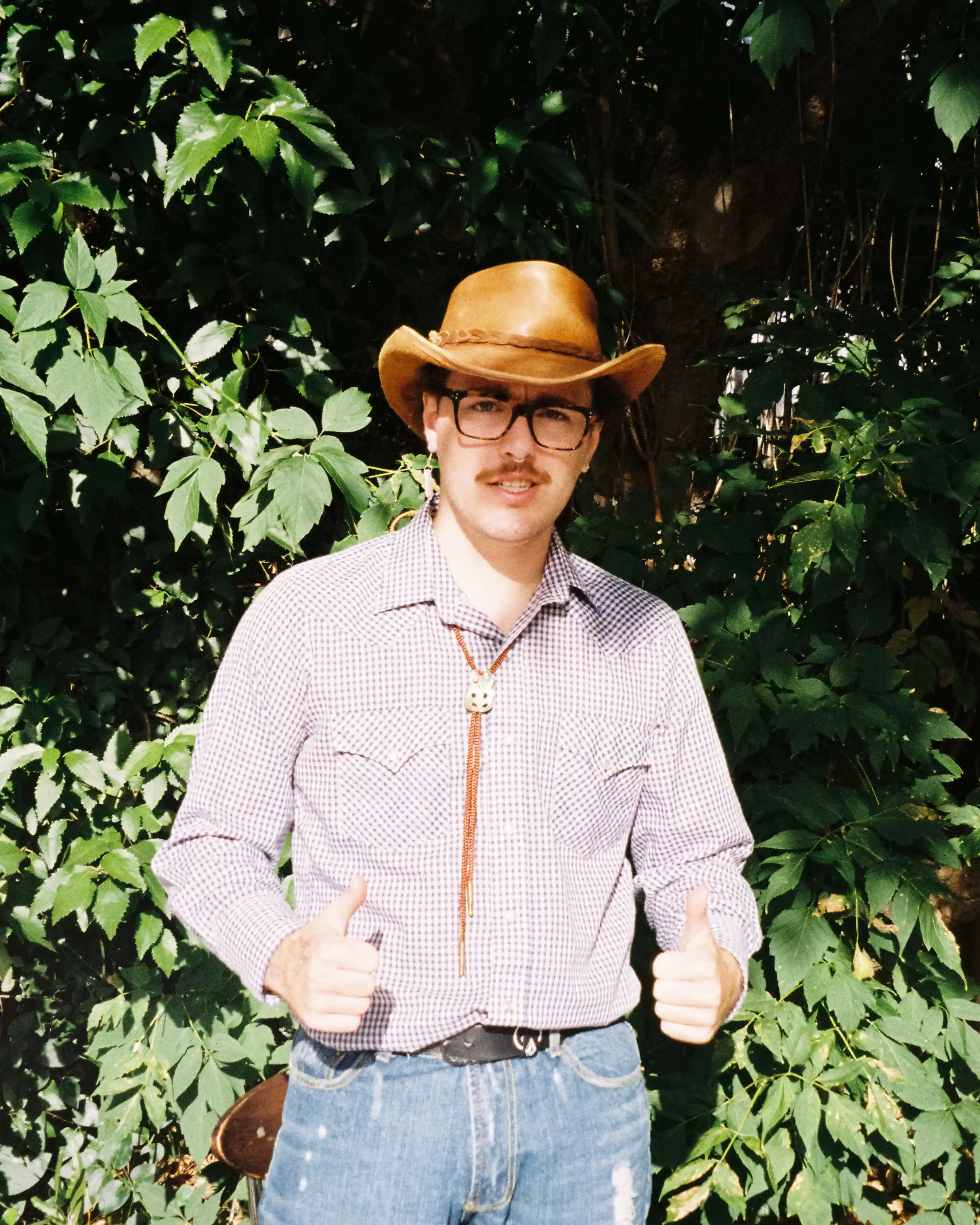Leonardo James wearing a cowboy costume posing with finger guns