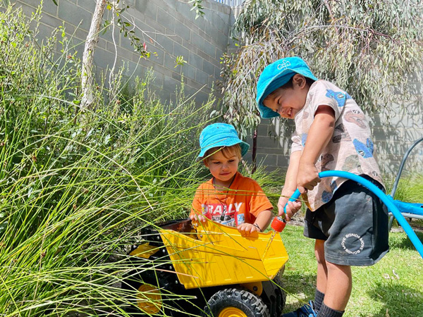 Children in kindy collaboratively playing in the garden at Little Saints Childcare, Bull Creek WA