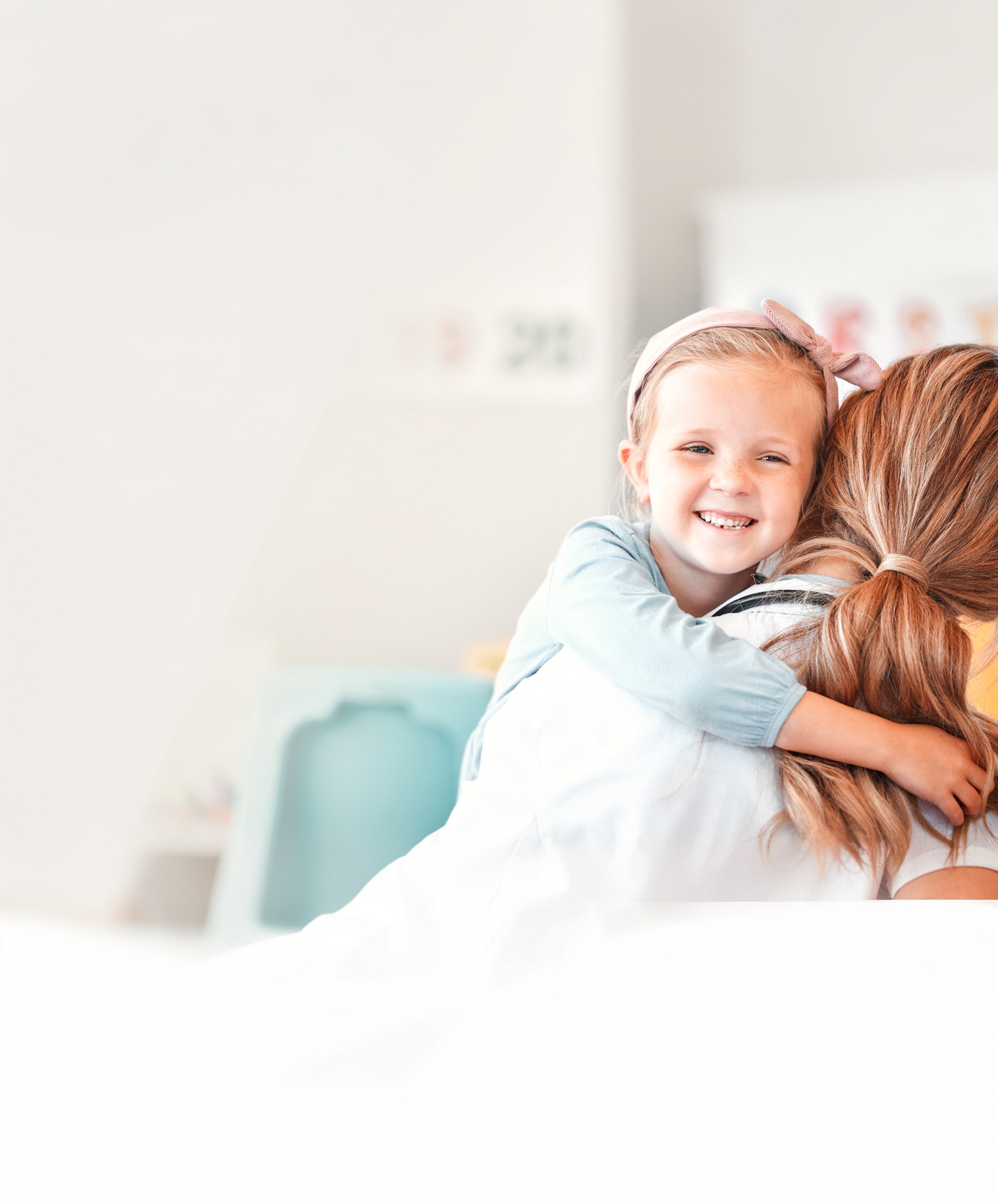 A child hugging their mother at home