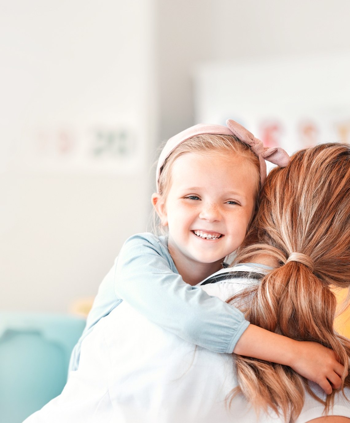 A child hugging their mother at home