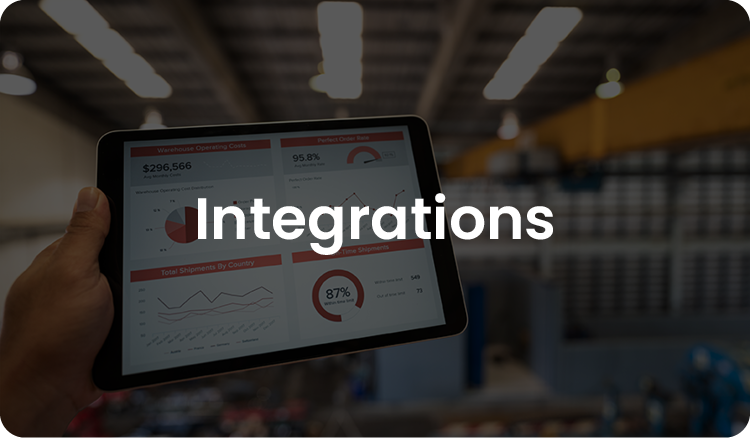 Hand holds tablet showing charts and graphs labeled "Integrations," with a blurred warehouse background suggesting data integration