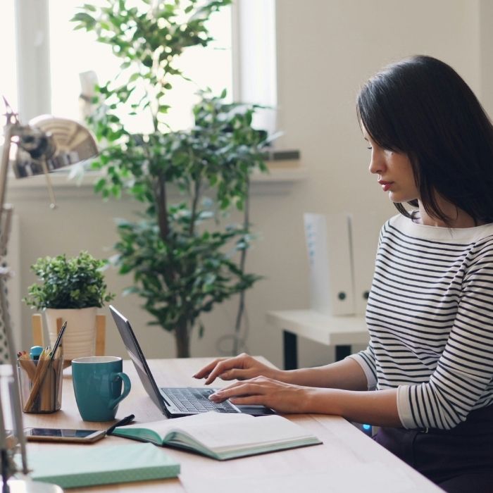 Female professional using her laptop at a desk
