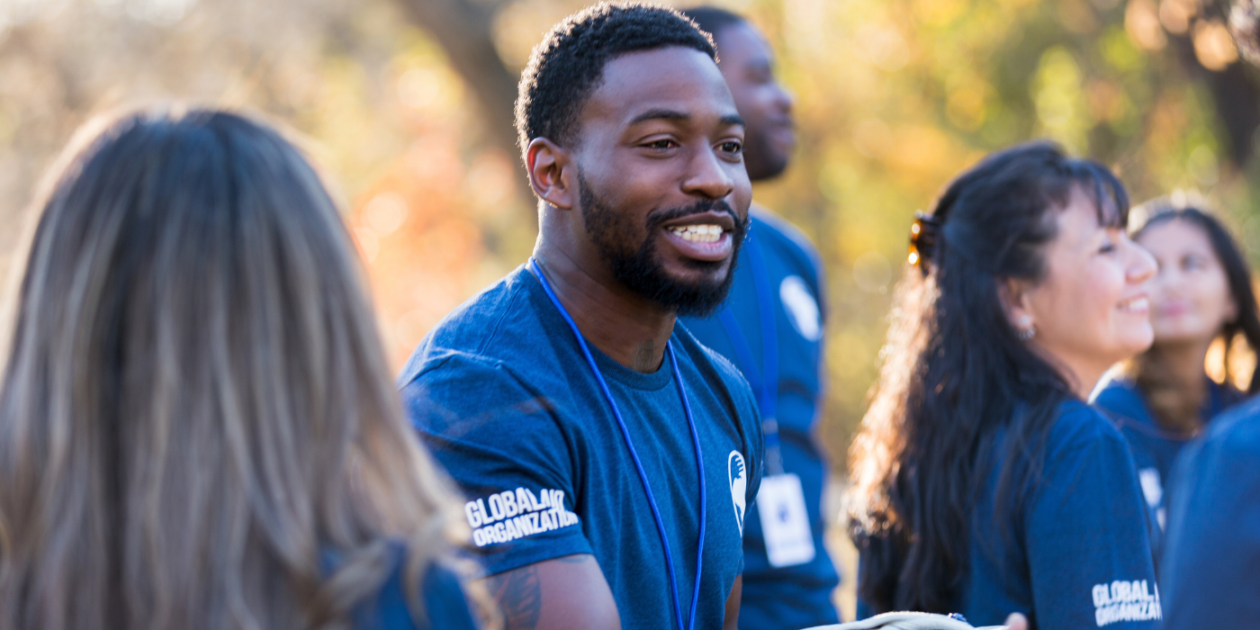 Charity Volunteer handing out shirts