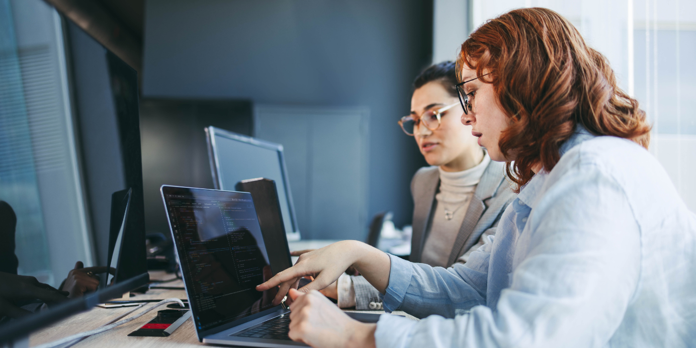 Two professional women looking at computer for Best Tools for WhatsApp Business Use blog post by ClientWindow