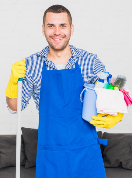 Cleaner holding a bucket of supplies and a cleaning cloth.