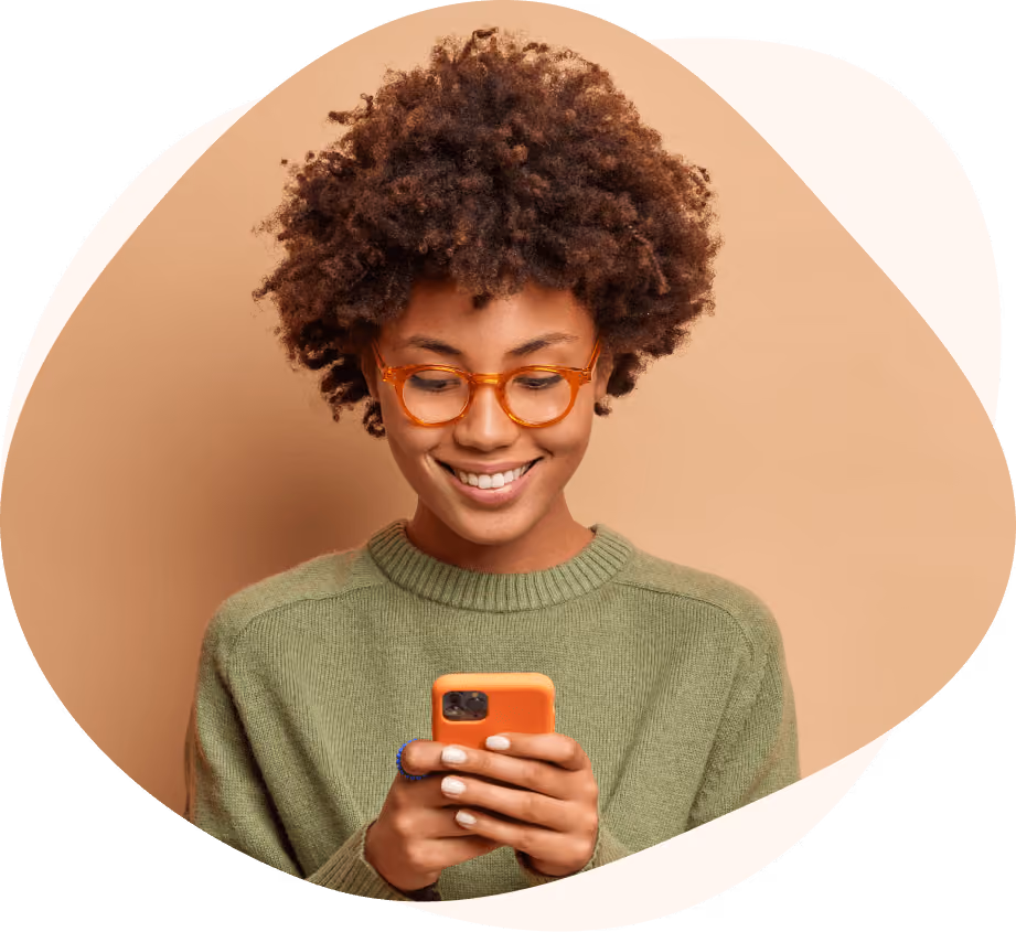 Smiling customer looking at a smartphone.