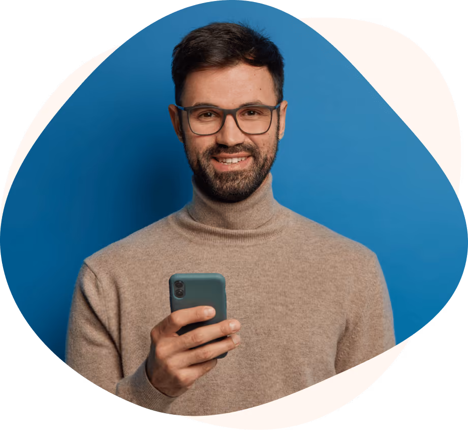 Smiling customer holding a smartphone.