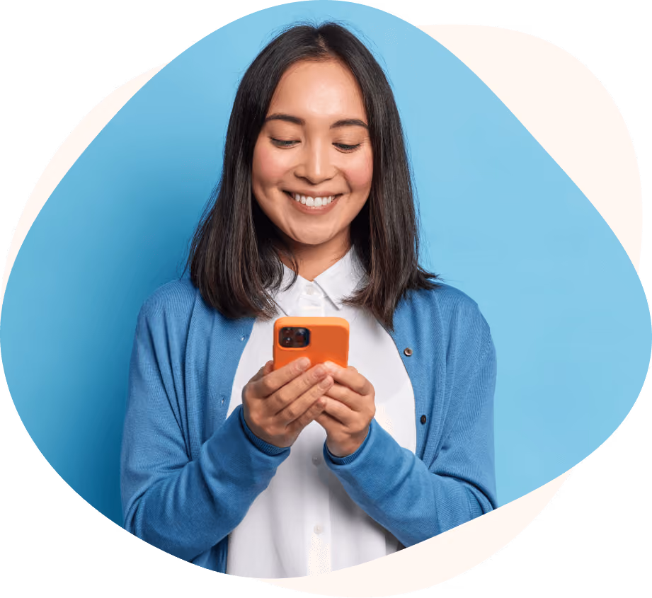 Customer smiling while reading a smartphone.