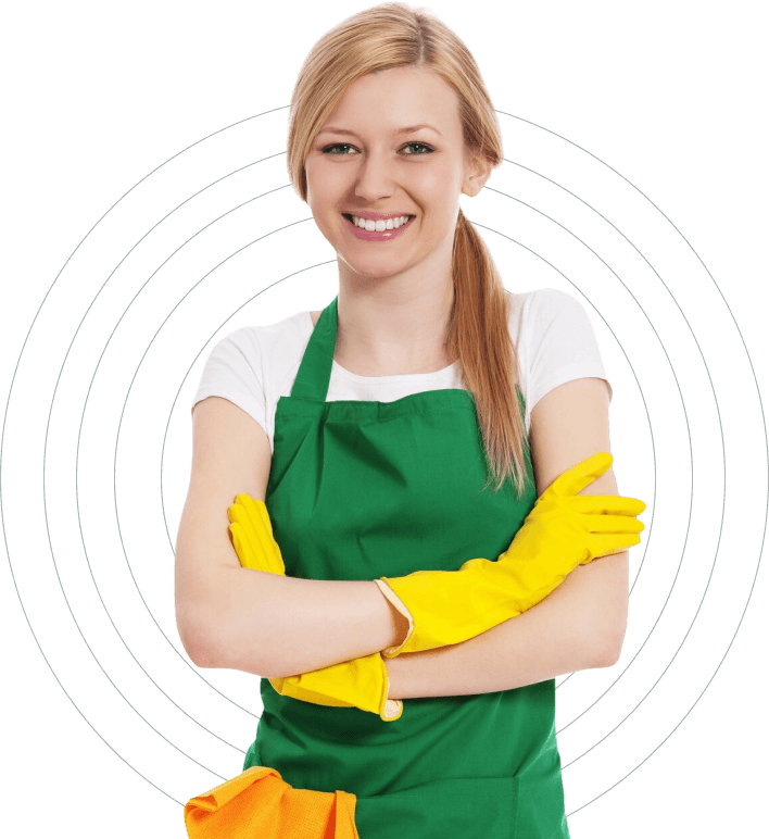 Smiling cleaner wearing a green apron and yellow gloves.