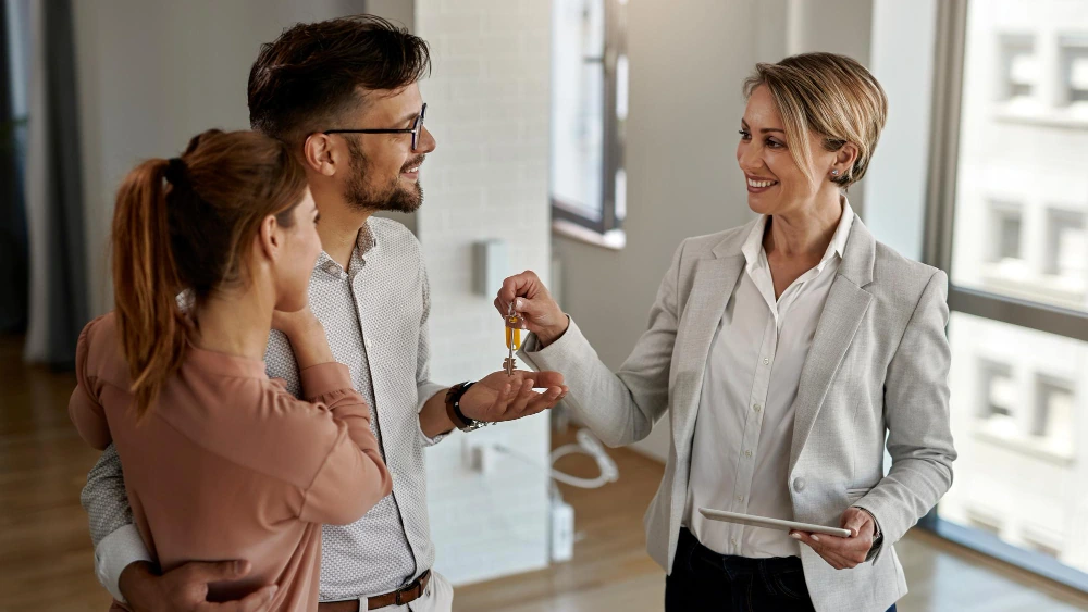 Clare May Real Estate agent helping buyers with a home handover in Brookwater
