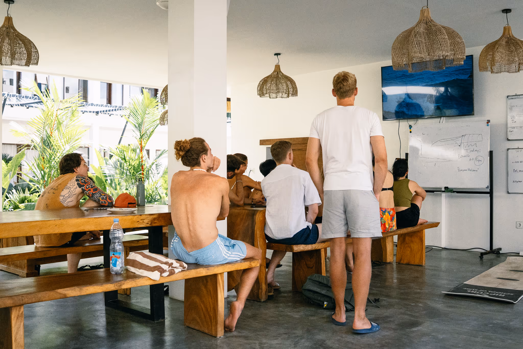 Kala Surf Camp guests reviewing surf footage with a coach in the video analysis room