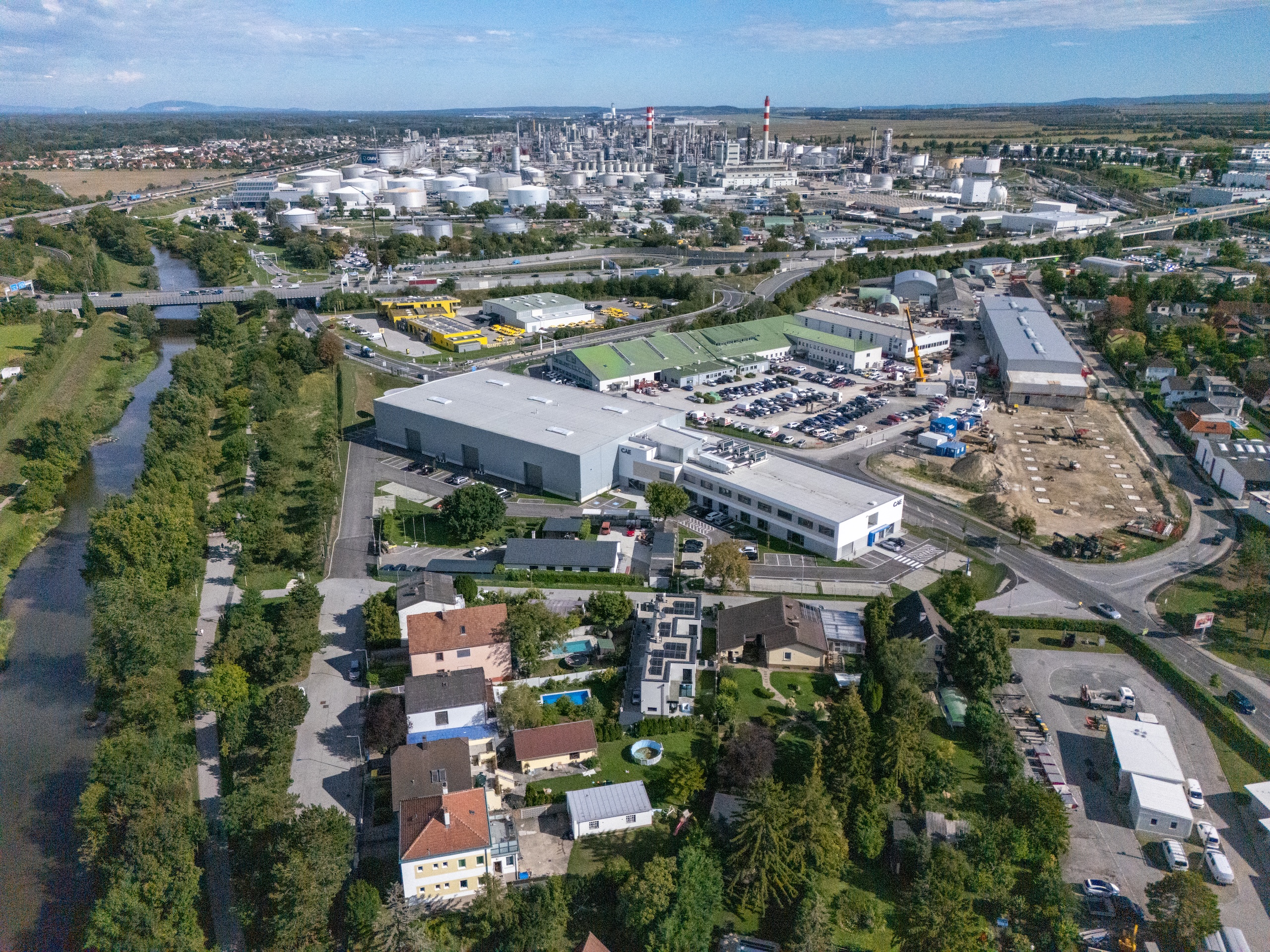 Aerial view of the completed CAE Flight Aviation Training Facility in Schwechat, showing the training hall and adjoining office building