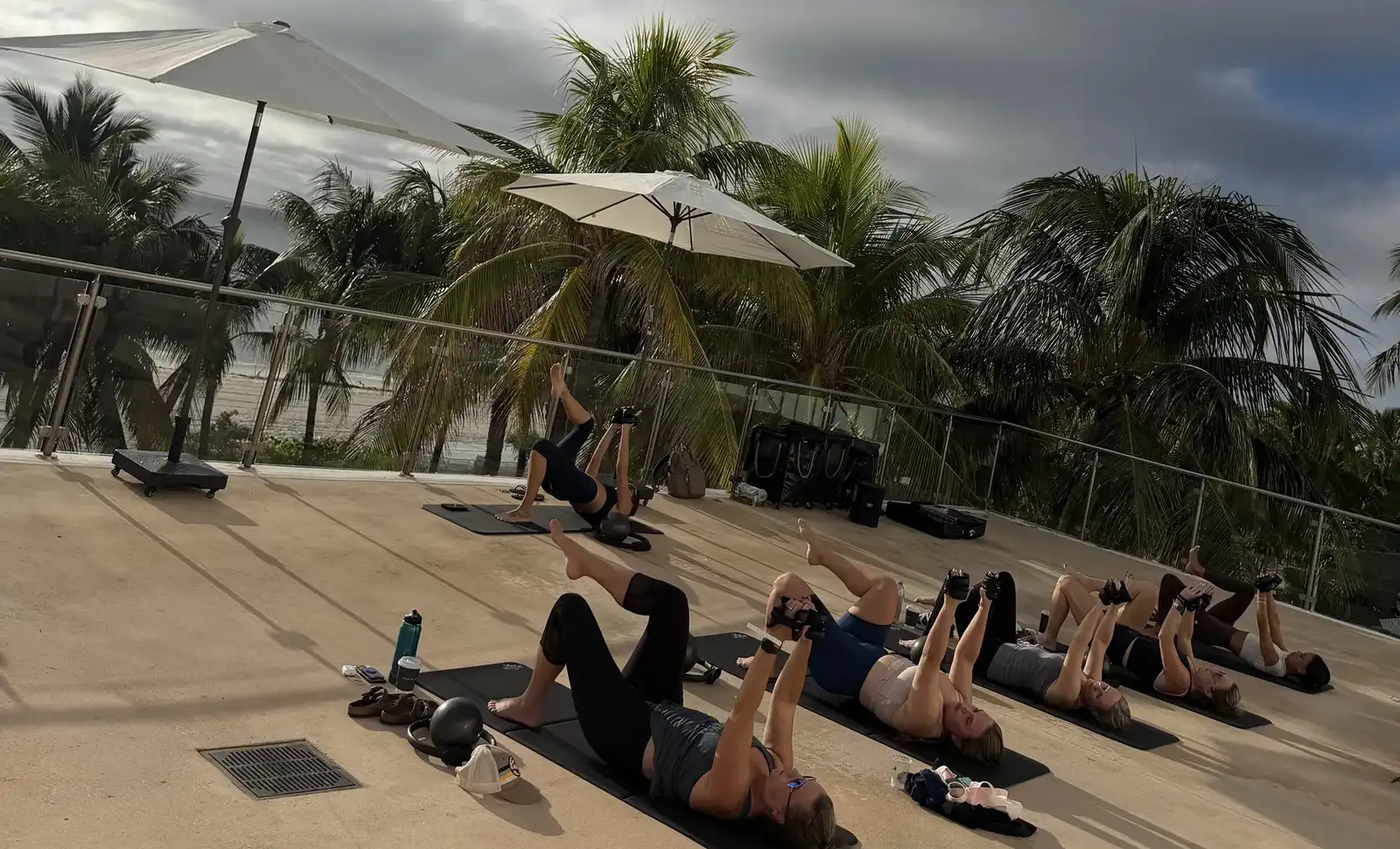 Outdoor mat Pilates class under palm trees at the Fontainebleau Miami Beach