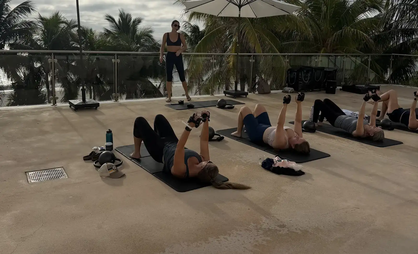 Beau Monde instructor leading an outdoor group mat Pilates class at the Fontainebleau Miami Beach