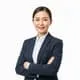 Smiling professional woman in a dark suit with arms crossed on white background.