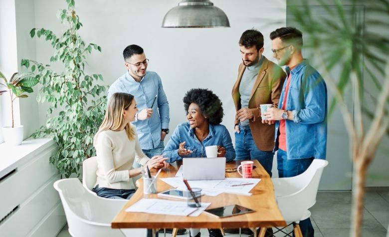 Group of employees strategizing their new systems after a successful merger