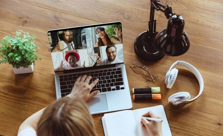 Graphic showing an employee engaging with remote teammates during a virtual meeting, symbolizing connection, collaboration, and culture-building in remote work environments.